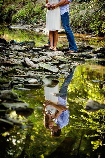 engagement portraits in a creek with a reflection at Turtle Creek Park in Highland park