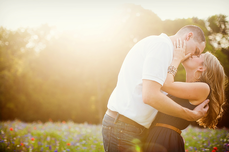 romantic engagement portraits with a kiss at Prairie Creek park in richardson