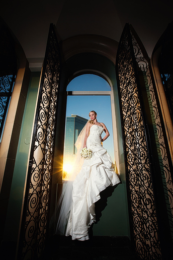 awesome bridal portraits in a window at the Fort Worth Club by Dallas wedding photographer Allison Davis Photography