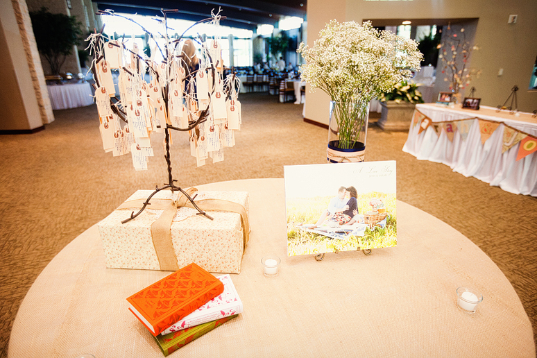 wedding day details of the rustic-inspired table centerpieces with mason jars candles and books at Prestonwood