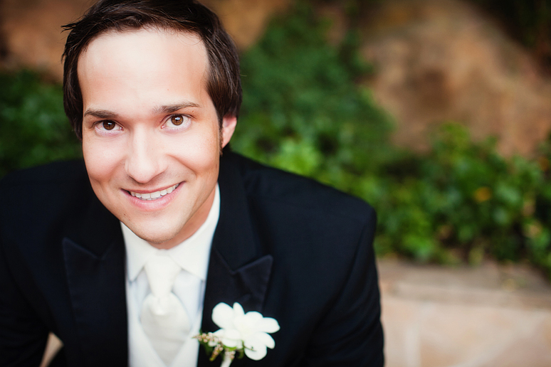 wedding day portraits of the groom in the Maple Manor Garden wedding ceremony space in downtown Dallas