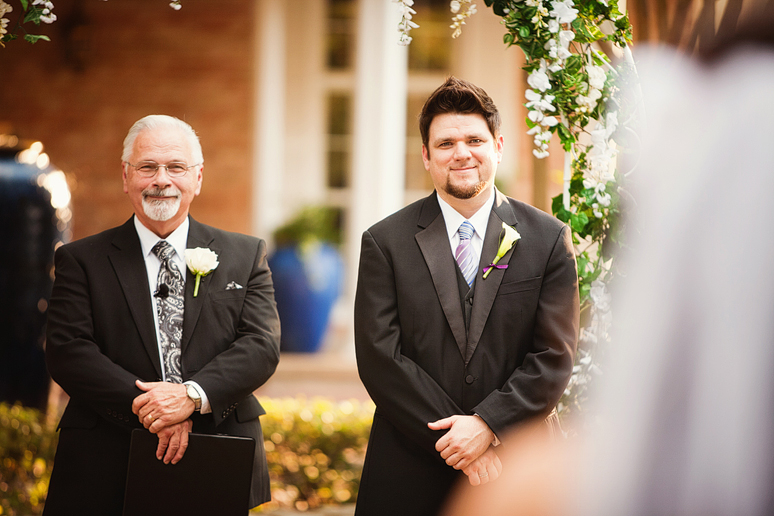 groom watching as bride walks down the aisle during their outdoor wedding ceremony at canyon creek country club