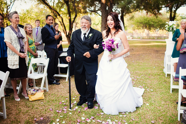 bride walking down rose petal path at her outdoor dallas wedding ceremony at a country club by Dallas wedding photographer Allison Davis Photography