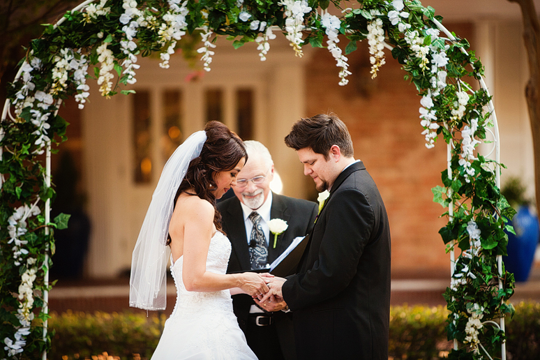 exchanging rings at beautiful outdoor wedding ceremony in North Texas at the canyon creek country club by dallas wedding photographer Allison Davis Photography