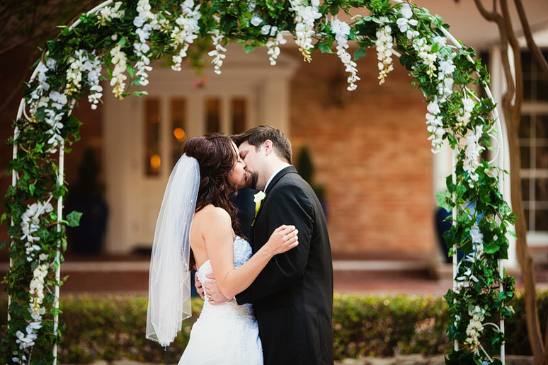 first kiss at outdoor wedding ceremony at canyon creek country club in richardson texas