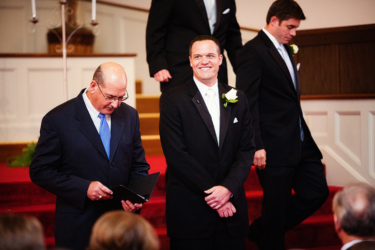 groom watching his bride enter the church at a baptist Church wedding by 