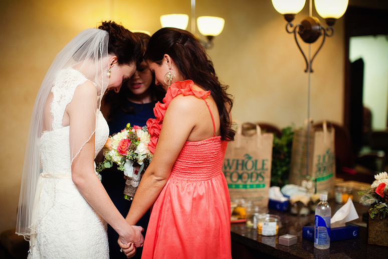 bride praying with her friends in the bridal suite at Prestonwood Baptist Church by Plano wedding photographer Allison Davis Photography