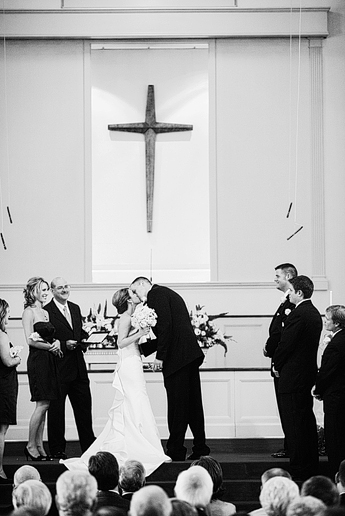 bride and groom wedding ceremony kiss at baptist Church wedding by Dallas wedding photographer Allison Davis