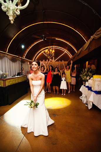 bridal bouquet toss at a wedding reception at the downtown Dallas bed and breakfast hotel the Maple Manor
