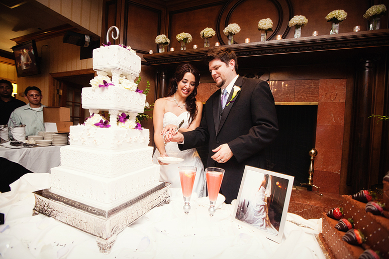 cutting the cake at a wedding reception at the canyon creek country club in Dallas Texas