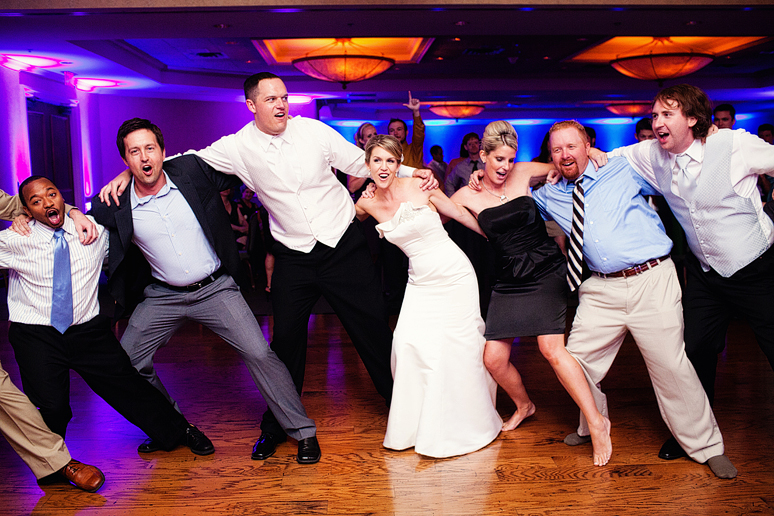Singing and dancing to the Aggie War Hymn at a wedding reception by Dallas wedding photographer Allison Davis