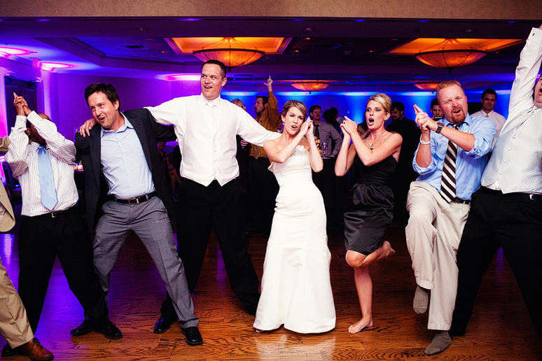 Singing and dancing to the Aggie War Hymn at a wedding reception by North Texas wedding photographer Allison Davis