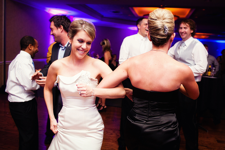 Singing and dancing to the Aggie War Hymn at a wedding reception by Plano wedding photographer Allison Davis