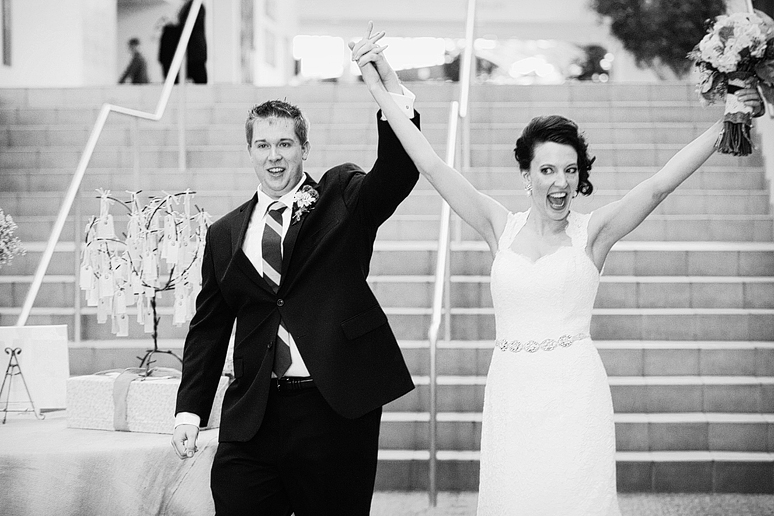 bride and groom celebrate their wedding reception entrance at Prestonwood by Dallas wedding photographer