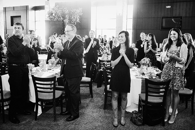guests clapping for the arrival of the bride and groom at their wedding reception at Prestonwood
