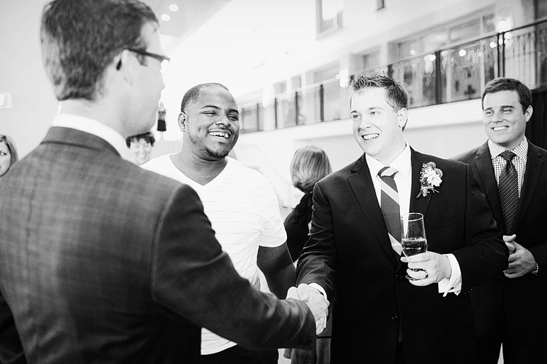 groom visiting with guests at their wedding reception at Prestonwood Baptist Church