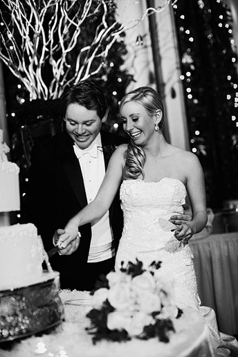 bride and groom cutting the cake at their wedding reception at the fort worth club