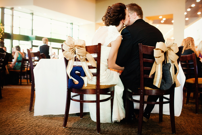 bride and groom in initial chairs at their wedding reception at Prestonwood Baptist Church