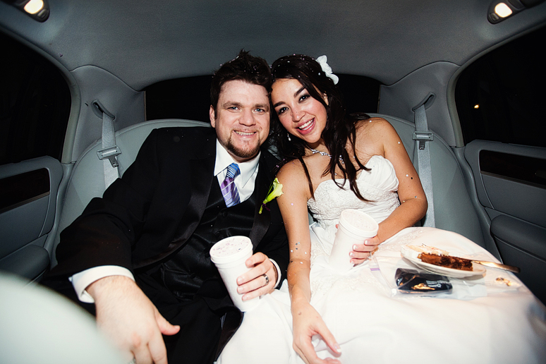 bride and groom inside getaway car