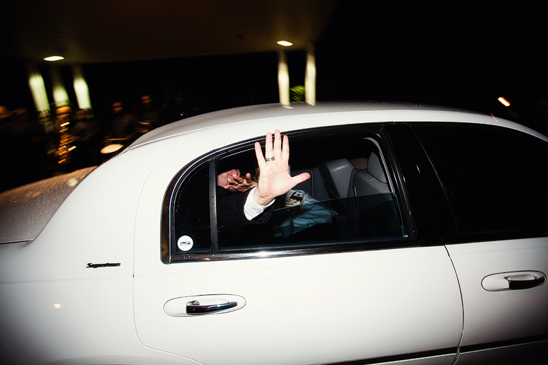 groom waving goodbye from getaway car