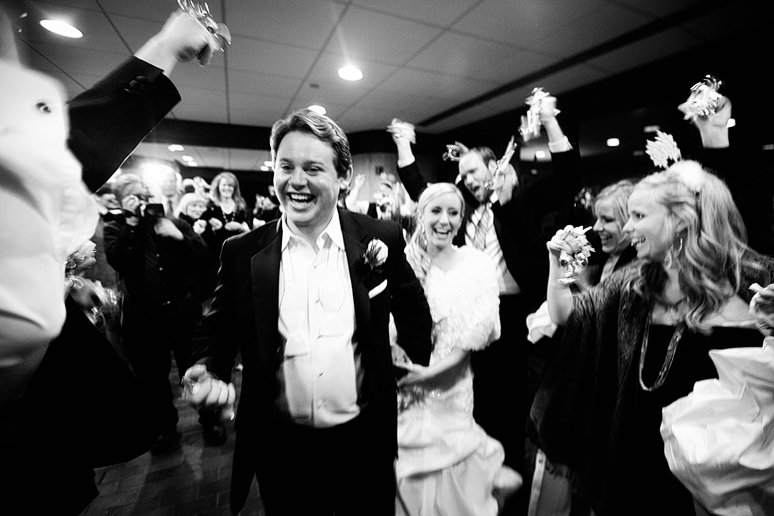 winter wedding exit with guests ringing bells