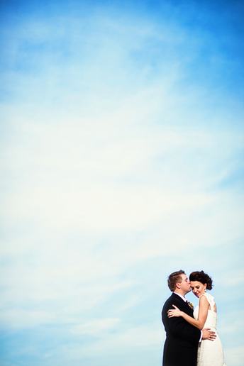 bride and groom on a beautiful blue sky background by Plano wedding photographer Allison Davis Photography