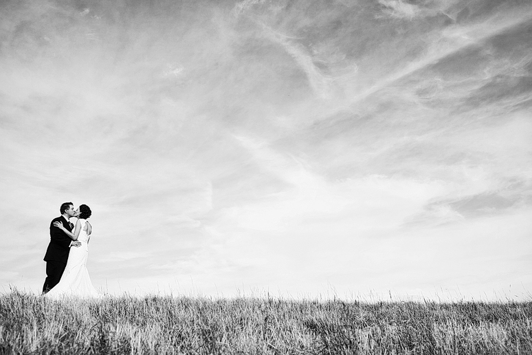 bride and groom atop a tall hill with tall grass by Dallas wedding photographer Allison Davis Photography