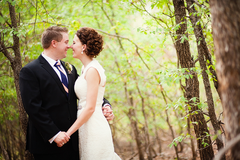 happy bride and groom portraits in a forest by Dallas wedding photographer