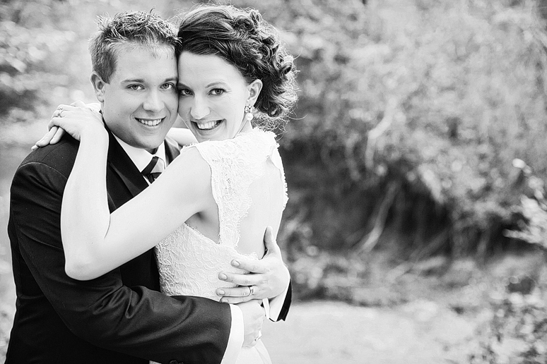 happy bride and groom portraits in a creek by Dallas wedding photographer Allison Davis