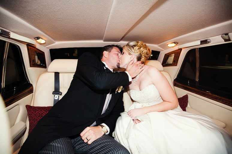 couple inside their wedding exit car a Rolls Royse